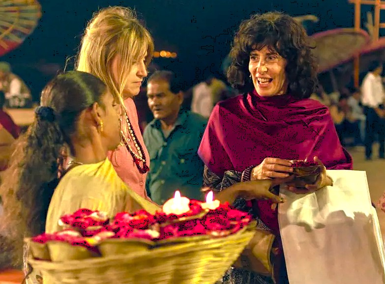  “Tourists in Varanasi’s vibrant evening festival near Sanarth Temple and Buddha shrine, Uttar Pradesh, India, gather around glowing candle-lit baskets, forging cultural connections while exploring rituals along the sacred Ganges.”