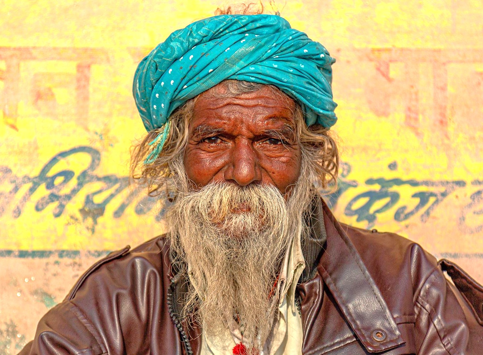 Portrait of an elderly local man with a long white beard and a bright turquoise turban in Varanasi, India, near the Kashi Vishwanath Temple and Sarnath UNESCO site. Portrait of an elderly local man with a long white beard and a bright turquoise turban in Varanasi, India, near the Kashi Vishwanath Temple and Sarnath UNESCO site.
