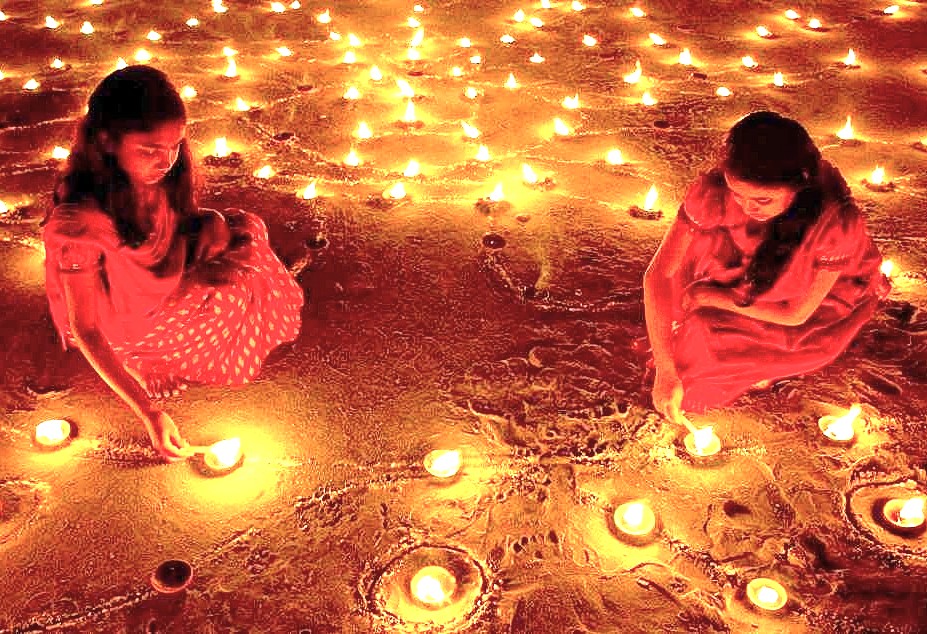 A Diwali celebration with women lighting diya lamps at Venkatappa Art Museum in Bangalore, Karnataka, India, a cultural attraction for tourists visiting near Mysore Palace.