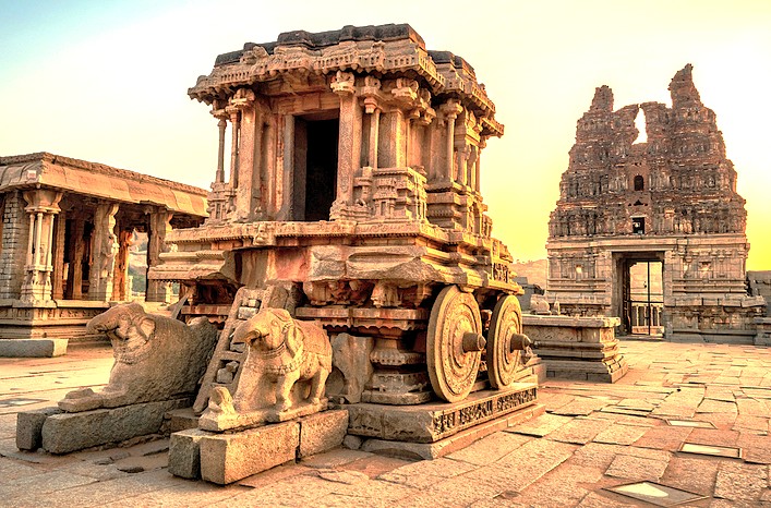 The iconic Stone Chariot at Vittala Temple is the centerpiece of the Hampi Unesco site in Karnataka, India, which also includes the Elephant stables and the queens baths.